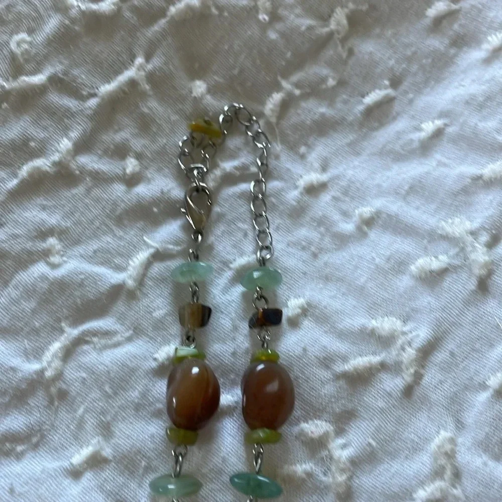Beautiful necklace. Gray, brown and light aqua stones with silver tone accents.